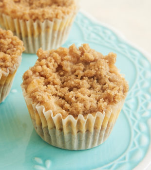 Mini Cinnamon Crumb Cheesecakes on a small blue pedestal