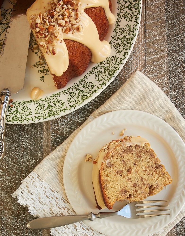 overhead view of a slice of Toasted Pecan Bundt Cake on a white plate