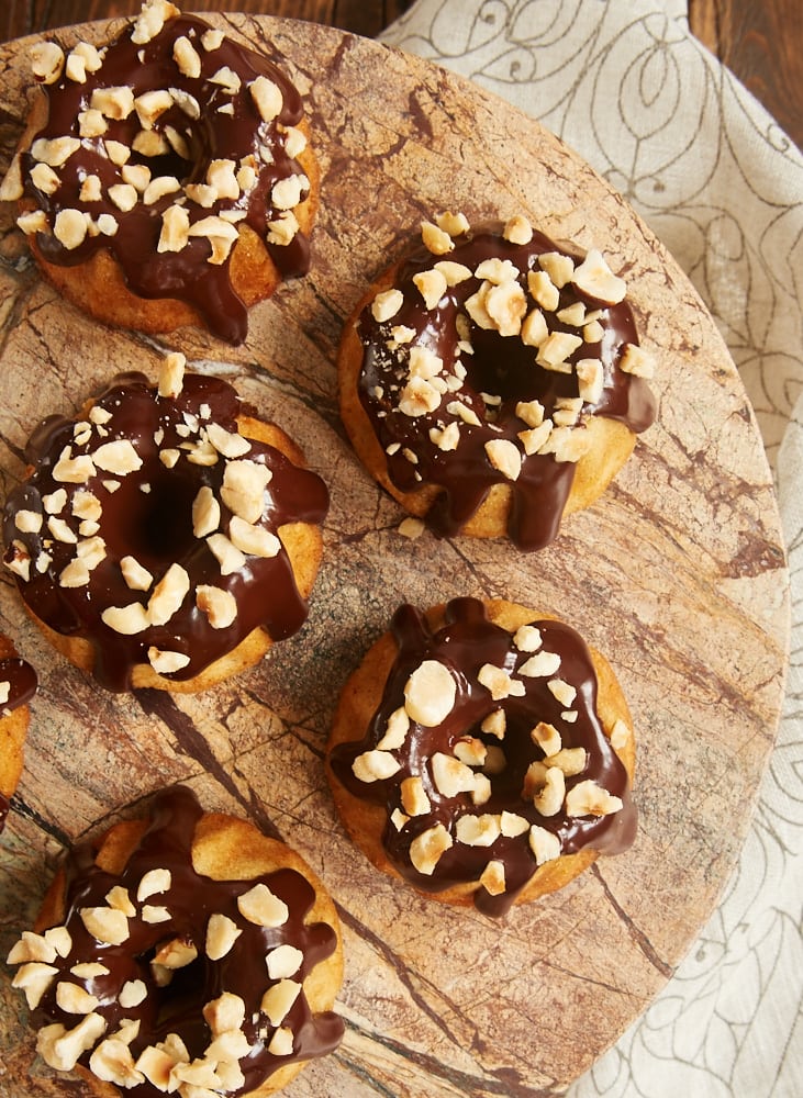 Brown Butter Hazelnut Bundt Cakes topped with dark chocolate ganache and chopped hazelnuts