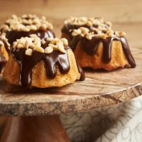 Brown Butter Hazelnut Bundt Cakes are little treats with big flavor. Toasted hazelnuts, browned butter, and dark chocolate ganache combine for an irresistibly delicious dessert! - Bake or Break