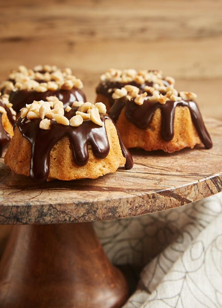 Brown Butter Hazelnut Bundt Cakes served on a dark marble cake stand