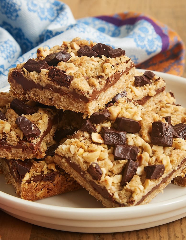 Chocolate Hazelnut Oat Bars stacked on a white plate