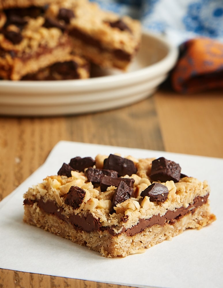 a slice of Chocolate Hazelnut Oat Bars on parchment paper