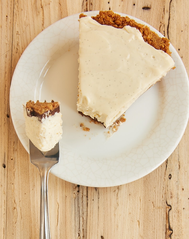 overhead view of a slice of No-Bake Black Bottom Vanilla Bean Cheesecake on a white plate