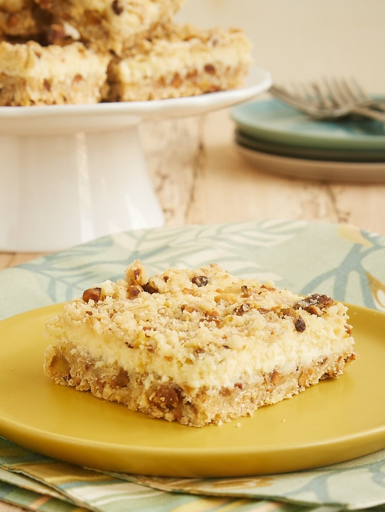 Lemon Pistachio Cheesecake Bar on a yellow plate