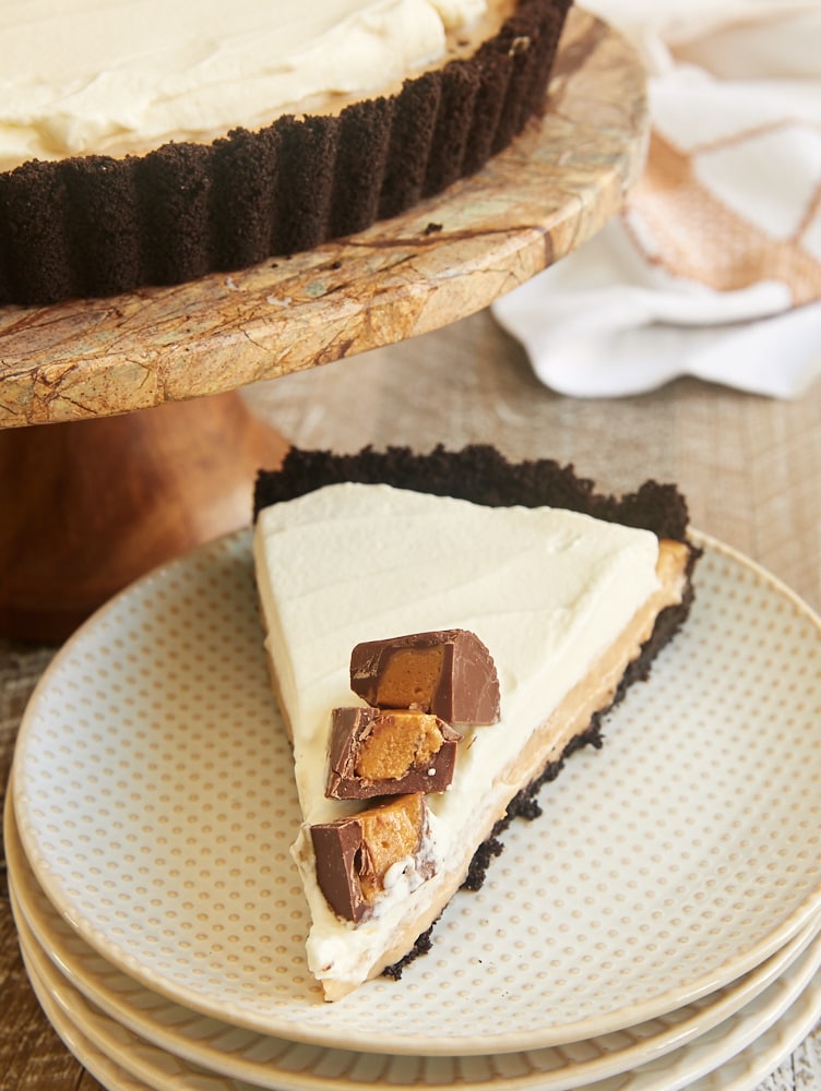 slice of Peanut Butter Pudding Pie on a white and beige plate