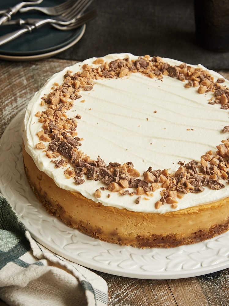 Brown Sugar Caramel Cheesecake with Oatmeal Cookie Crust on a round white serving tray