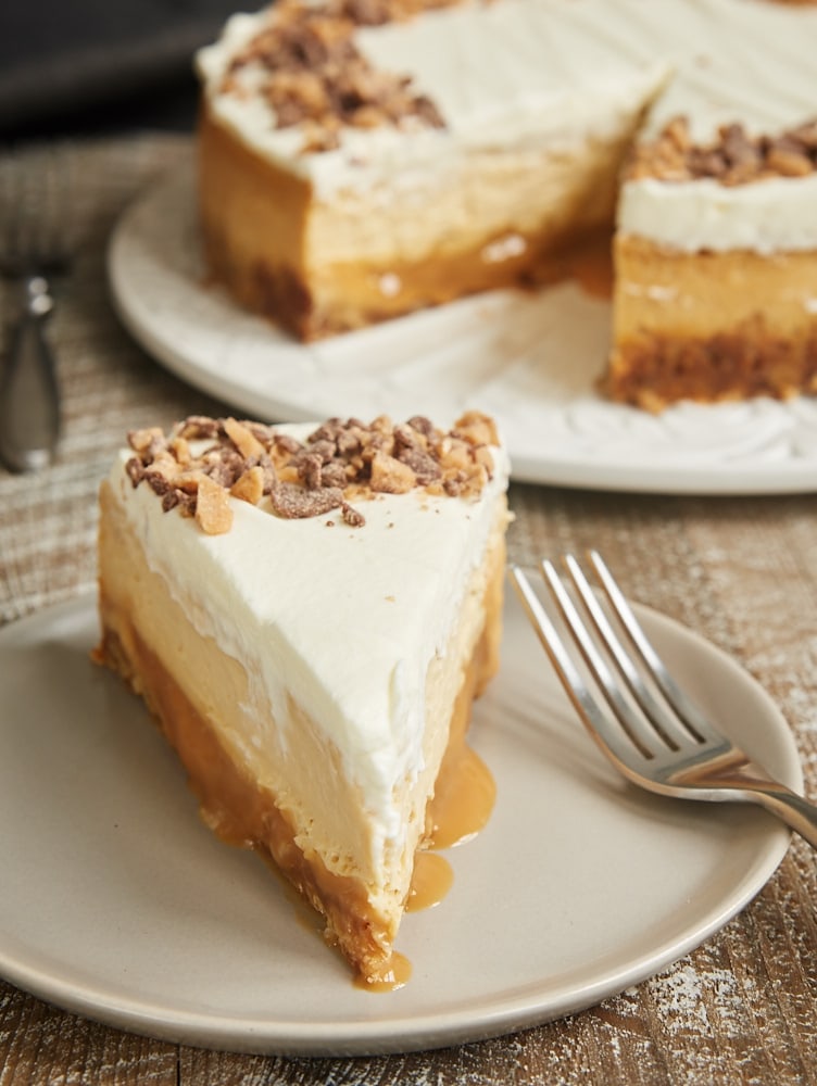 slice of Brown Sugar Caramel Cheesecake with Oatmeal Cookie Crust on a light gray plate