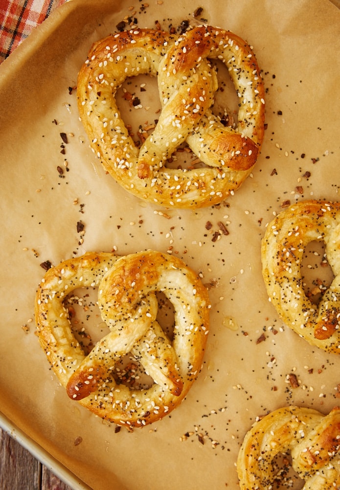 overhead shot of Everything Soft Pretzels on a parchment-lined baking sheet