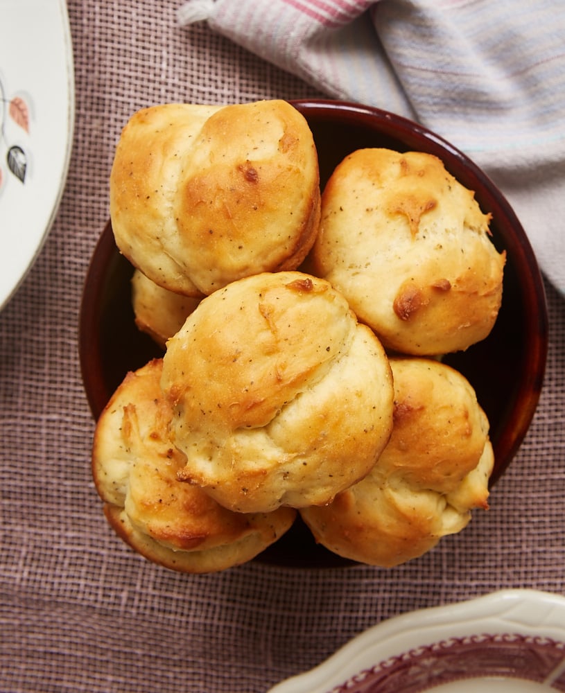 overhead view of Cracked Pepper Sour Cream Rolls in a brown bowl
