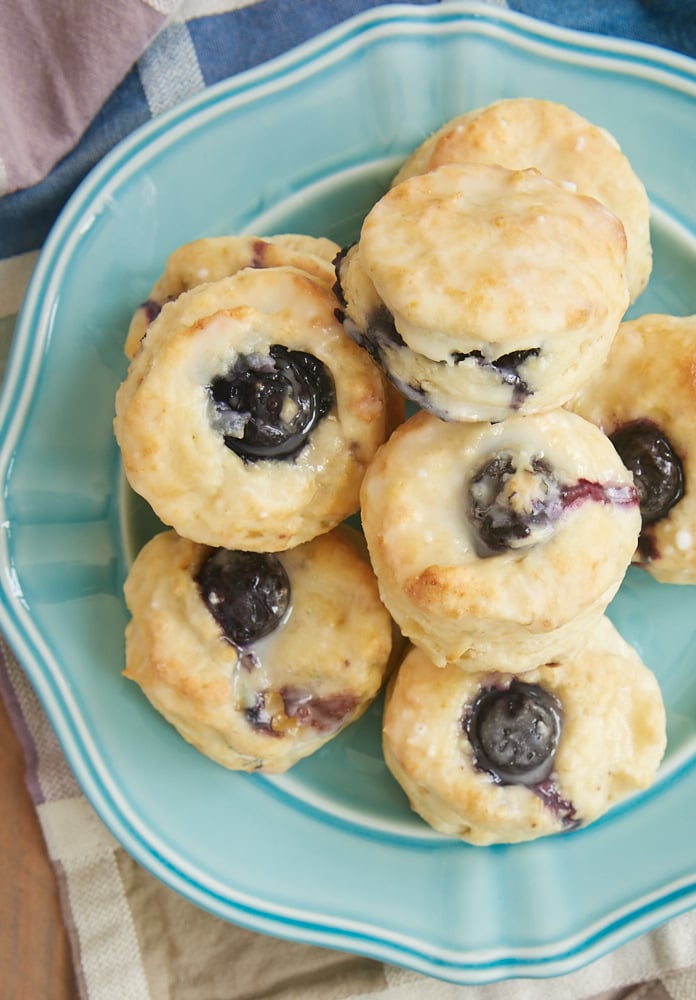 Glazed Blueberry Cream Cheese Biscuits on a blue plate