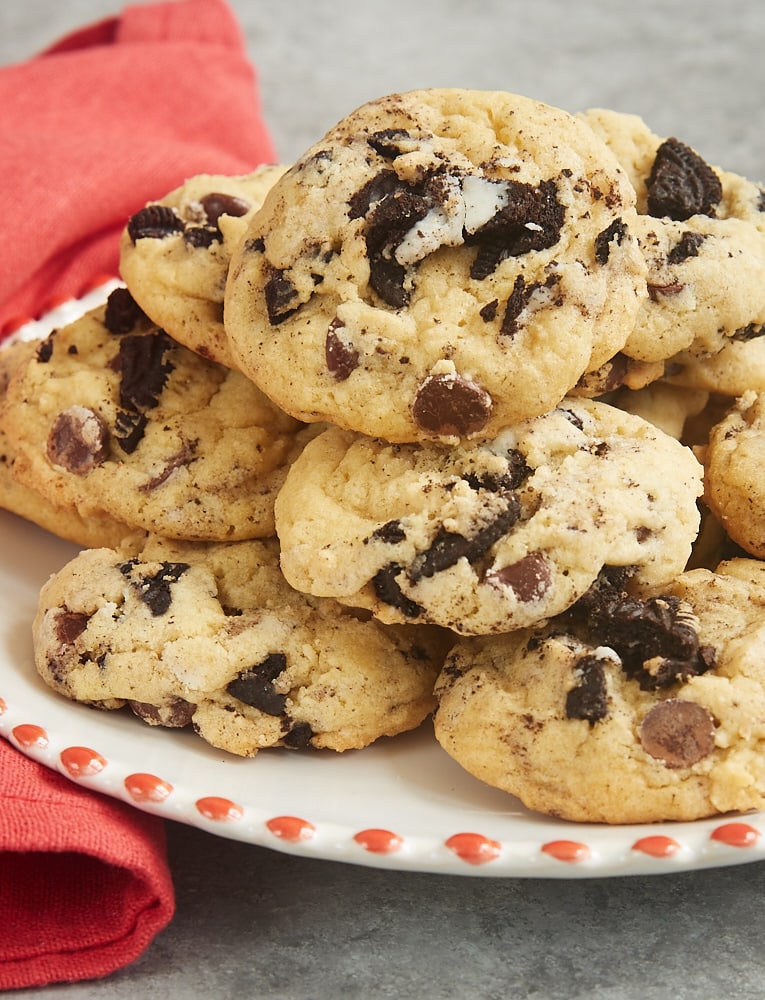 Cookies and Cream Chocolate Chip Cookies piled on a red-rimmed white plate