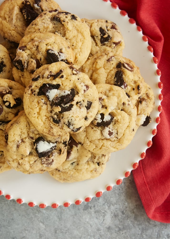 Overhead view of Cookies and Cream Chocolate Chip Cookies on a red-rimmed white plate