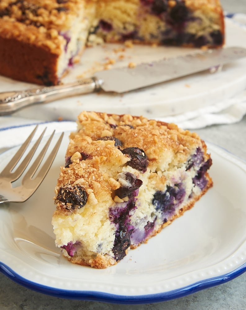 slice of Blueberry Coffee Cake on a blue-rimmed white plate