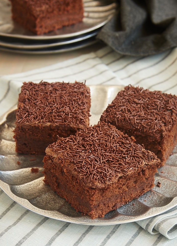 Three chocolate cream cheese brownies set out on a plate.