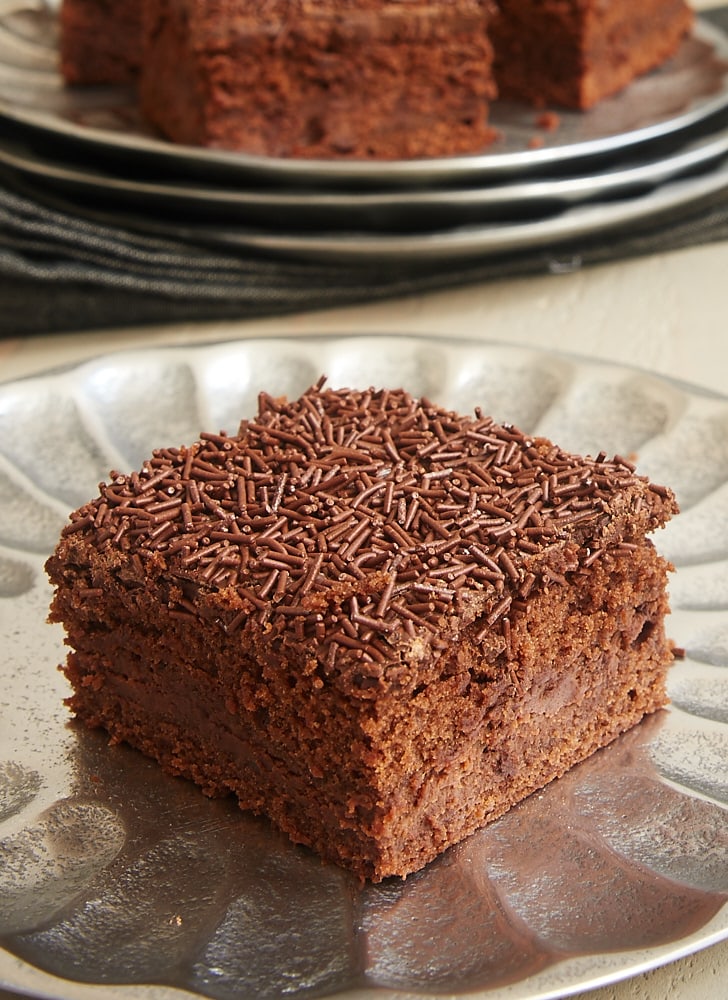 A side view of a brownie with a layer of chocolate cream cheese in the middle.