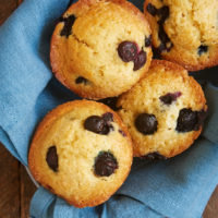 overhead view of Blueberry Muffins in a basket lined with a blue napkin