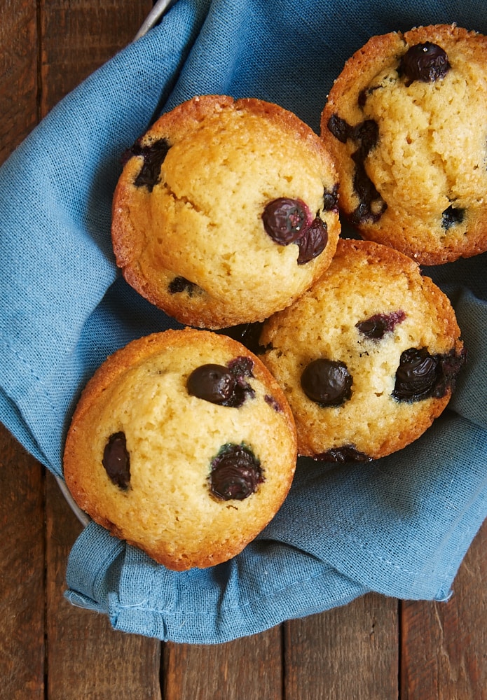 overhead view of Blueberry Muffins in a bowl lined with a blue towel