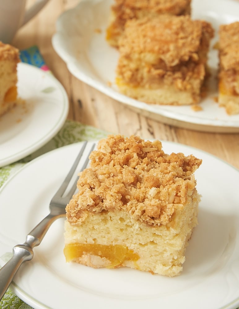 slice of Peach Cobbler Coffee Cake on a green-rimmed white plate