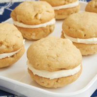 White Chocolate Macadamia Sandwich Cookies are a fun, frosted twist on a classic cookie. That white chocolate frosting is fantastic! - Bake or Break