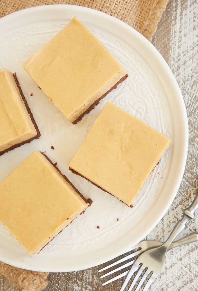 overhead view of slices of Brownie Bottom Peanut Butter Pie Bars on a white plate