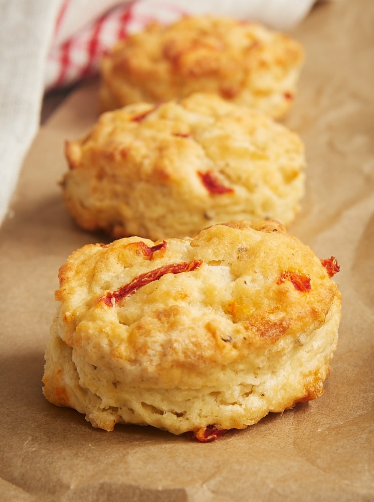 Pimiento Cheese Biscuits lined up on a sheet of parchment paper