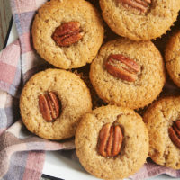 overhead view of Brown Butter Sour Cream Spice Muffins in a towel-line tray