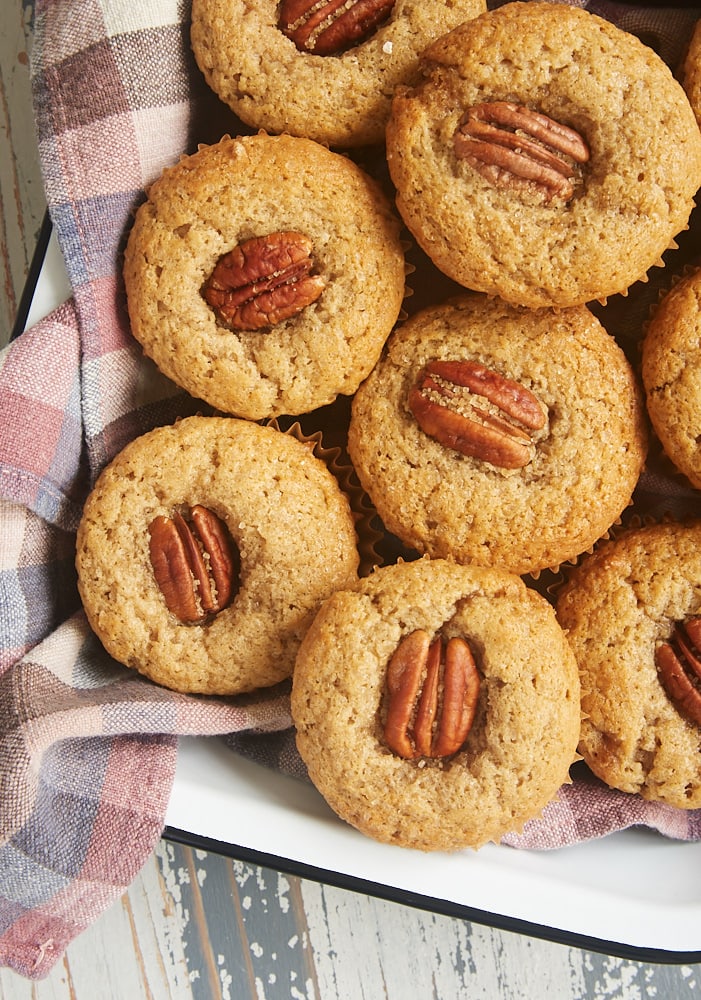 overhead view of Brown Butter Sour Cream Spice Muffins in a towel-line tray