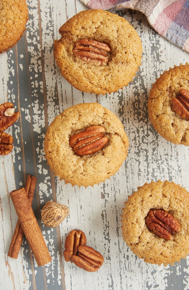 Brown Butter Sour Cream Spice Muffins on a wooden surface