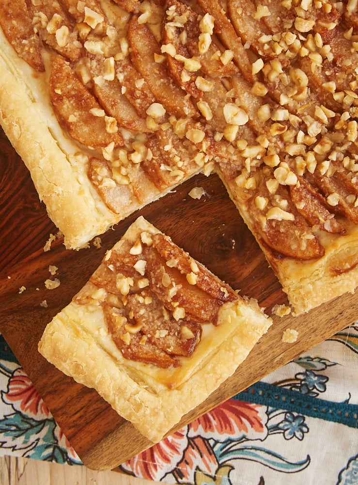 overhead view of Cream Cheese-Filled Pear Tart on a wooden cutting board