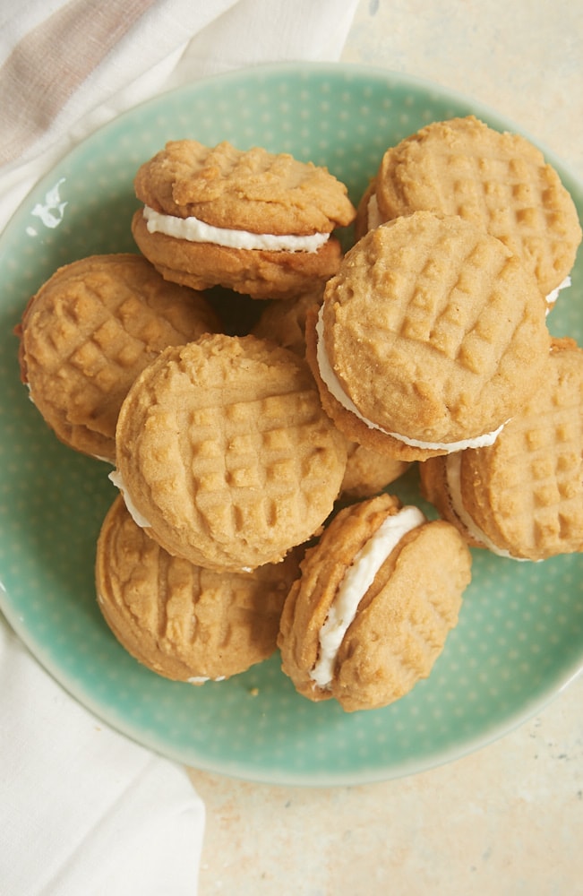 overhead view of Peanut Butter Marshmallow Sandwich Cookies on a green plate