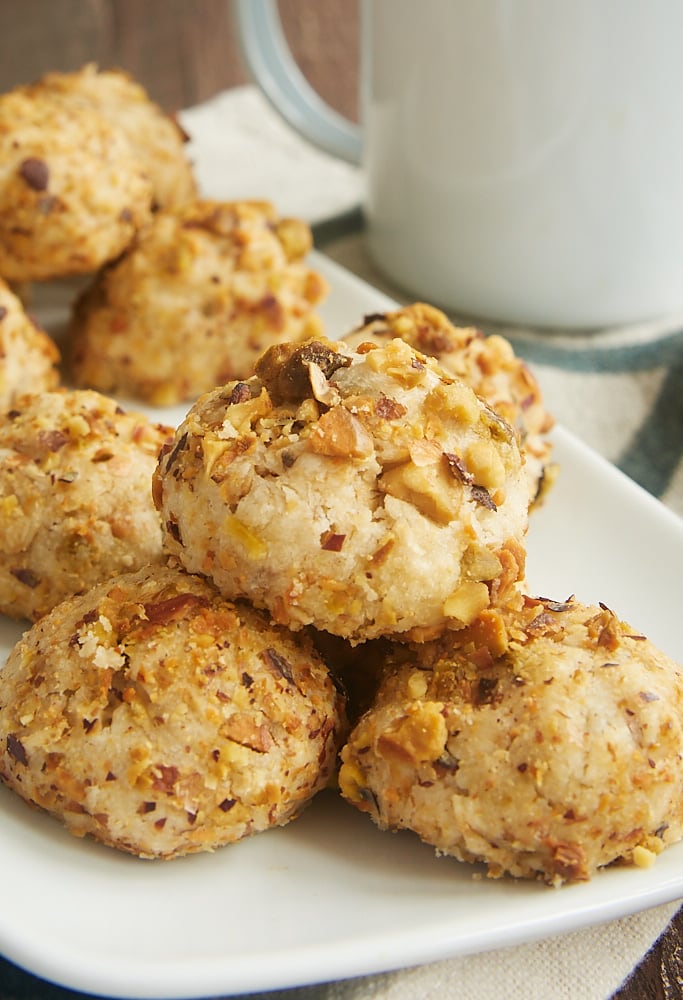 Pistachio sandies stacked on a plate.