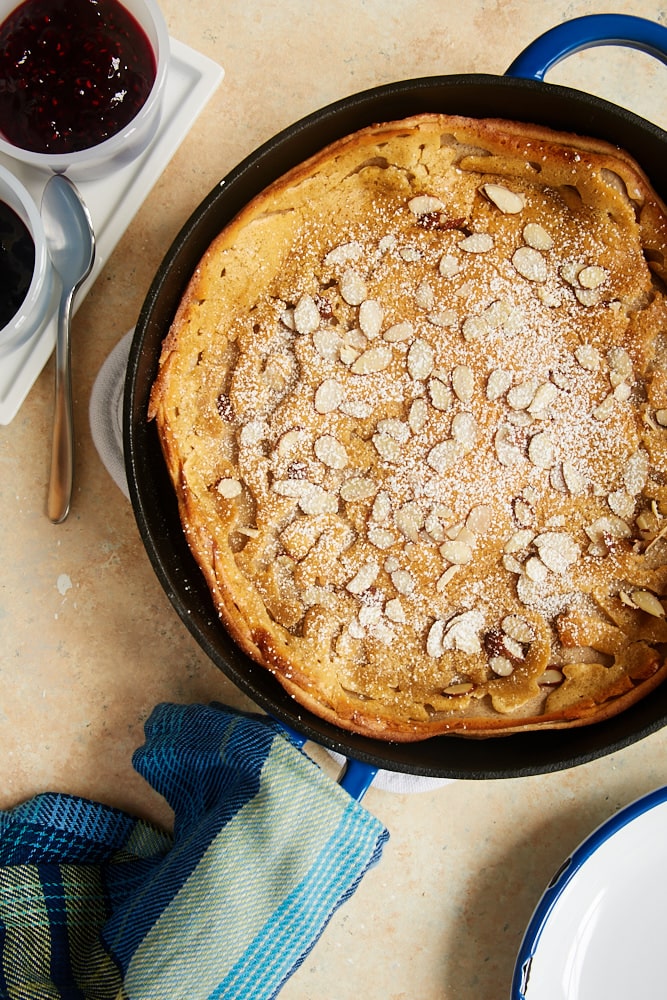 overhead view of Cinnamon Almond Dutch Baby Pancake in a cast iron skillet