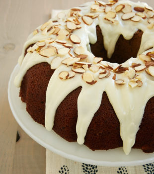 Blueberry Jam Cake topped with a cream cheese glaze and almonds - Bake or Break