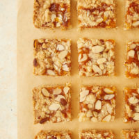 Apricot Almond Oat Bars on parchment paper