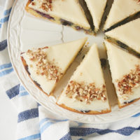 slices of Blueberry Snack Cake with Cream Cheese Frosting on a white serving plate