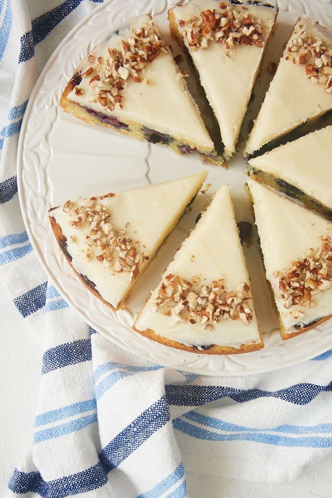 slices of Blueberry Snack Cake with Cream Cheese Frosting on a white serving plate