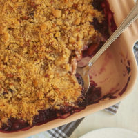 Blueberry Peach Crisp in square baking dish with serving spoon