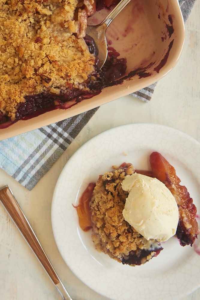 Blueberry Peach Crisp on plate with scoop of ice cream