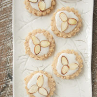 Almond Spice Cookies topped with a simple glaze and sliced almonds