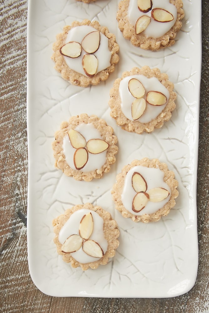 Almond spice cookies topped with a simple glaze and sliced almonds.