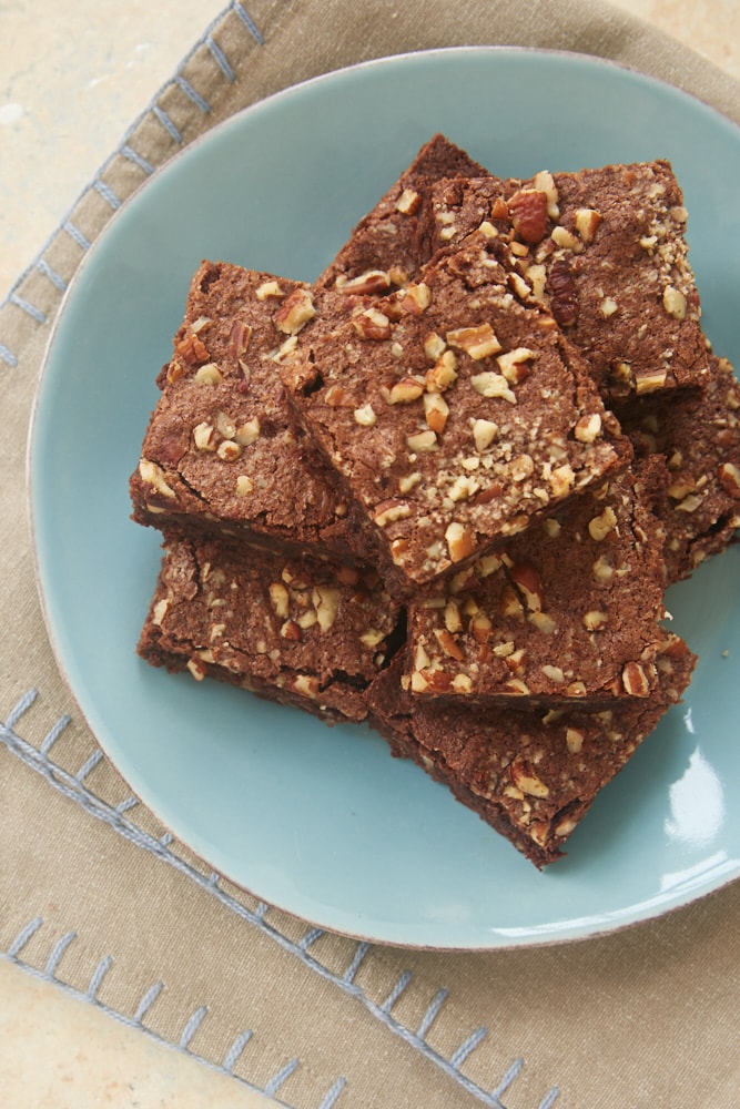 Double Chocolate Cinnamon Pecan Brownies on a blue plate