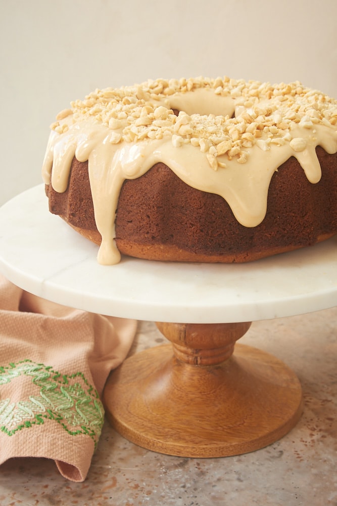 Peanut Butter Bundt Cake on a wooden and marble cake stand