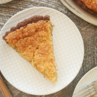 slices of Coconut Chess Pie with Chocolate Crust on white plates