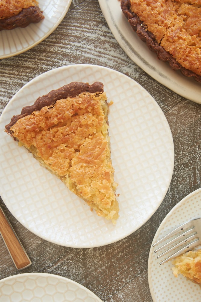 slices of Coconut Chess Pie with Chocolate Crust on white plates