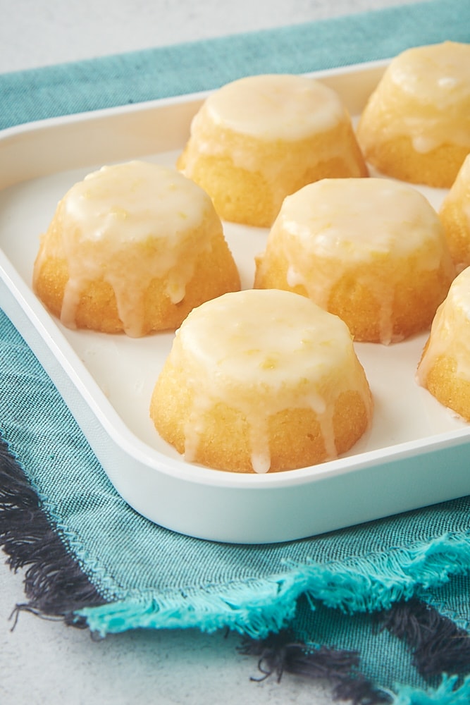 Mini Pound Cakes arranged on a white serving tray, topped with a lemon glaze