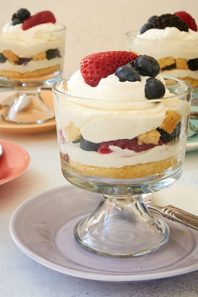 Berry Cheesecake Trifles topped with whipped cream and more berries