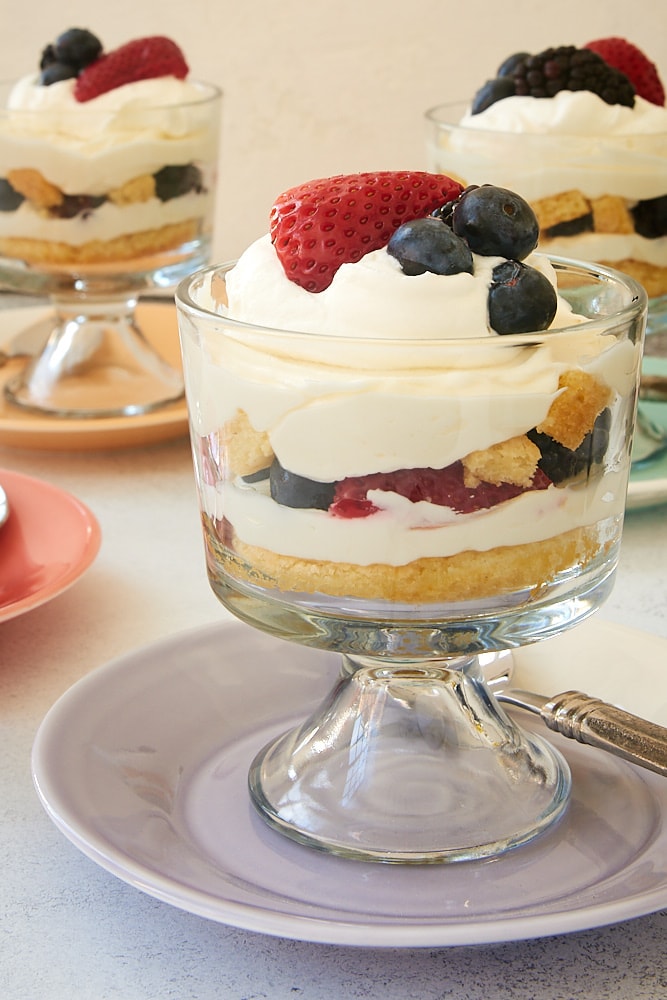 Individual Berry Cheesecake Trifles topped with whipped cream and more berries