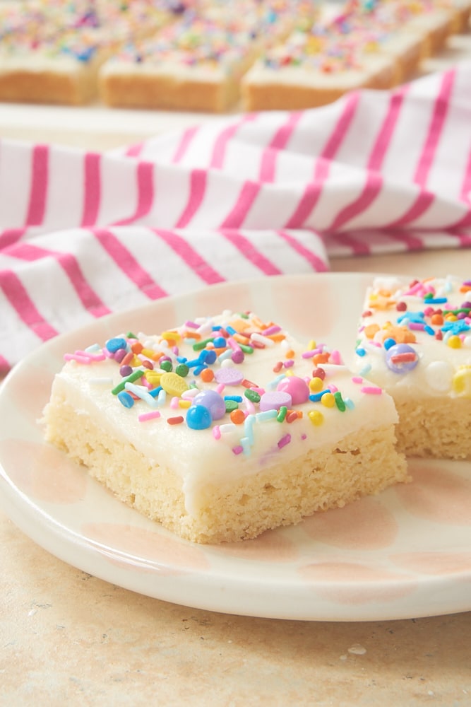 Frosted sugar cookie bars topped with sprinkles.