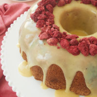 White Chocolate Raspberry Bundt Cake on a white cake stand